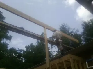 Carpenter setting a ridge beam over a new addition frame — Ice Dam Removal by Roofing Brothers in Dammeron Valley