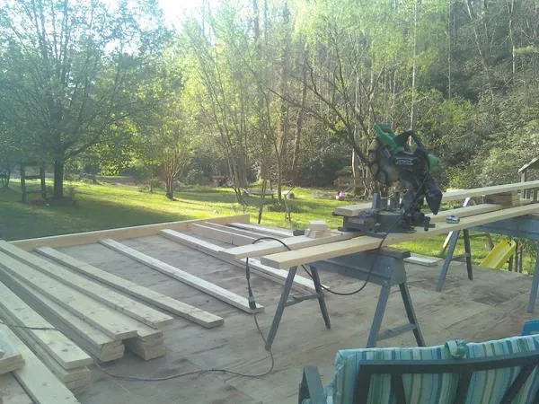 Miter saw and framing lumber on a deck under construction in Dammeron Valley