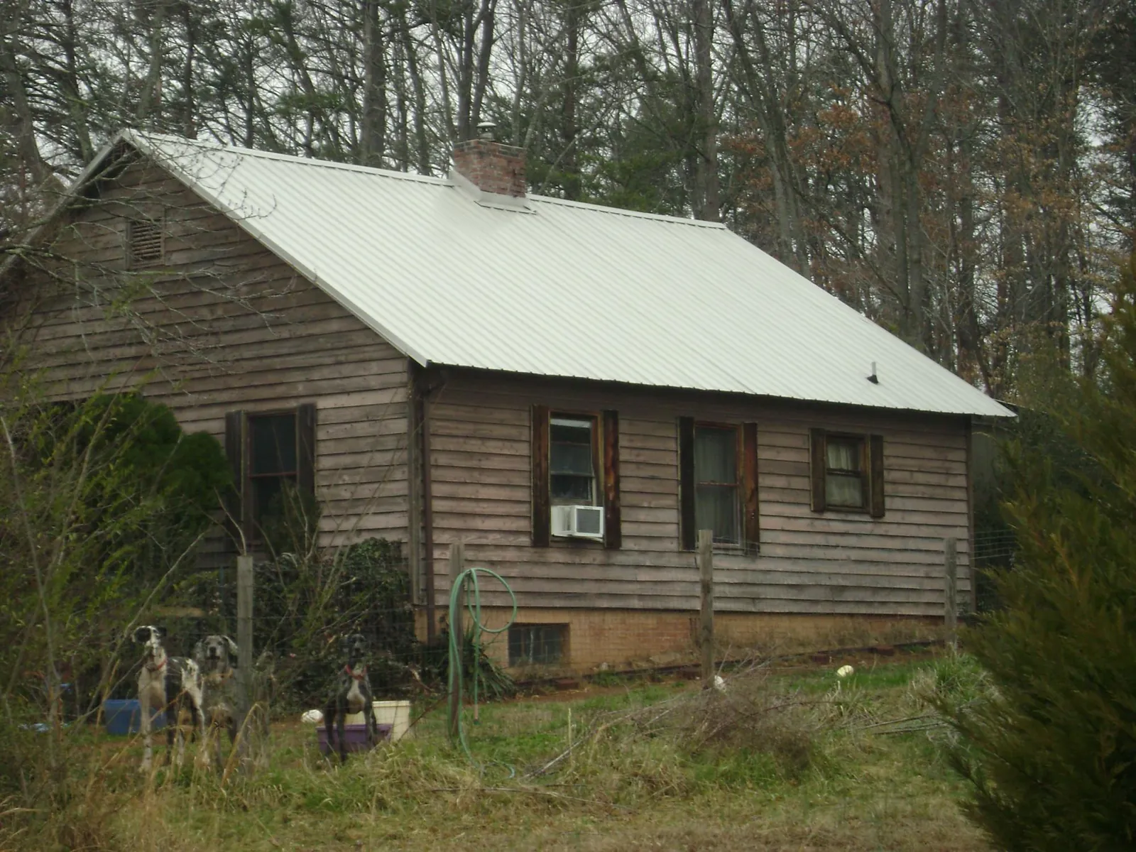 White metal roof on an old wood sided farmhouse, from a Metal Roof Installation job in Dammeron Valley